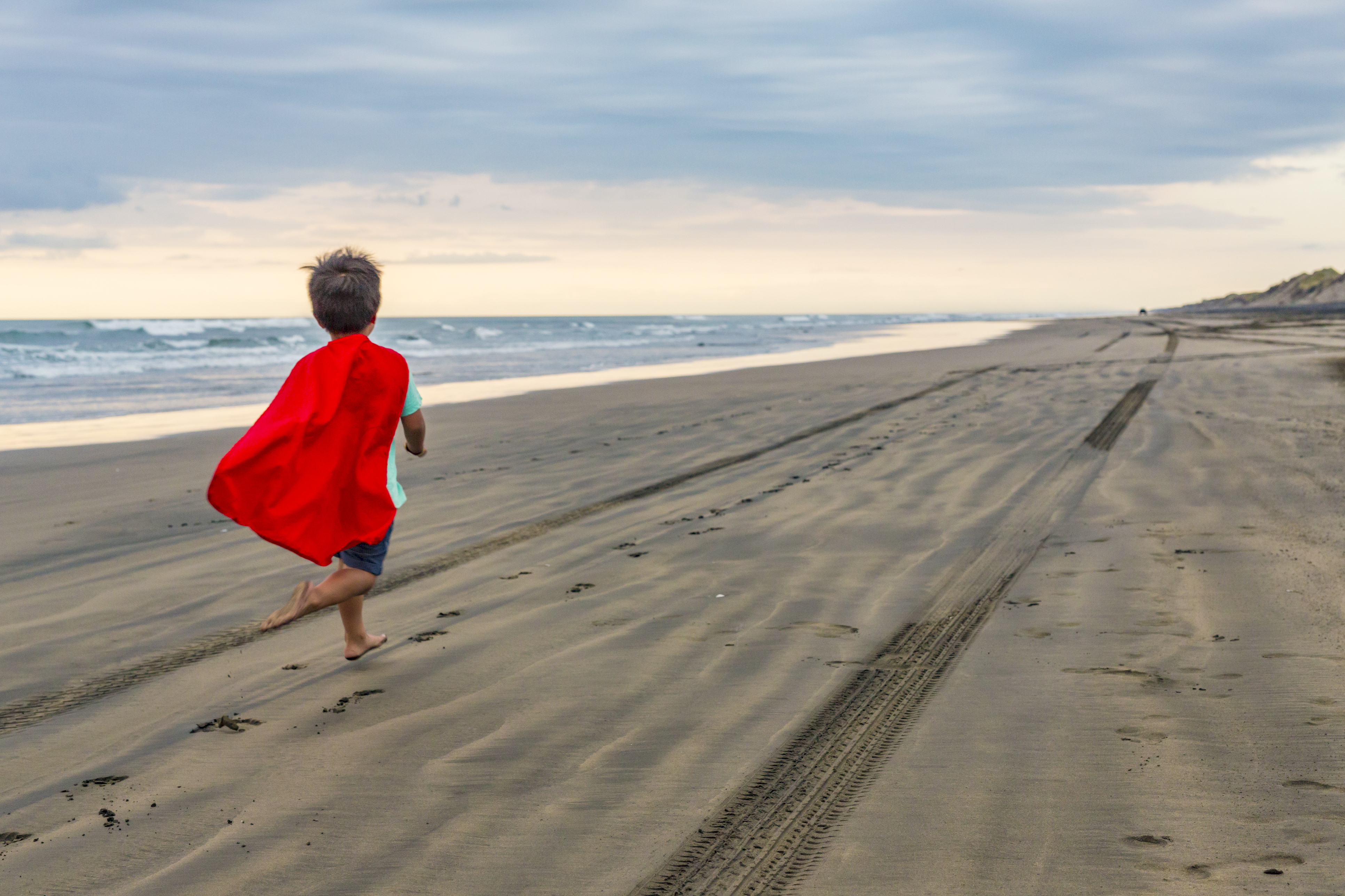 child wearing red cape