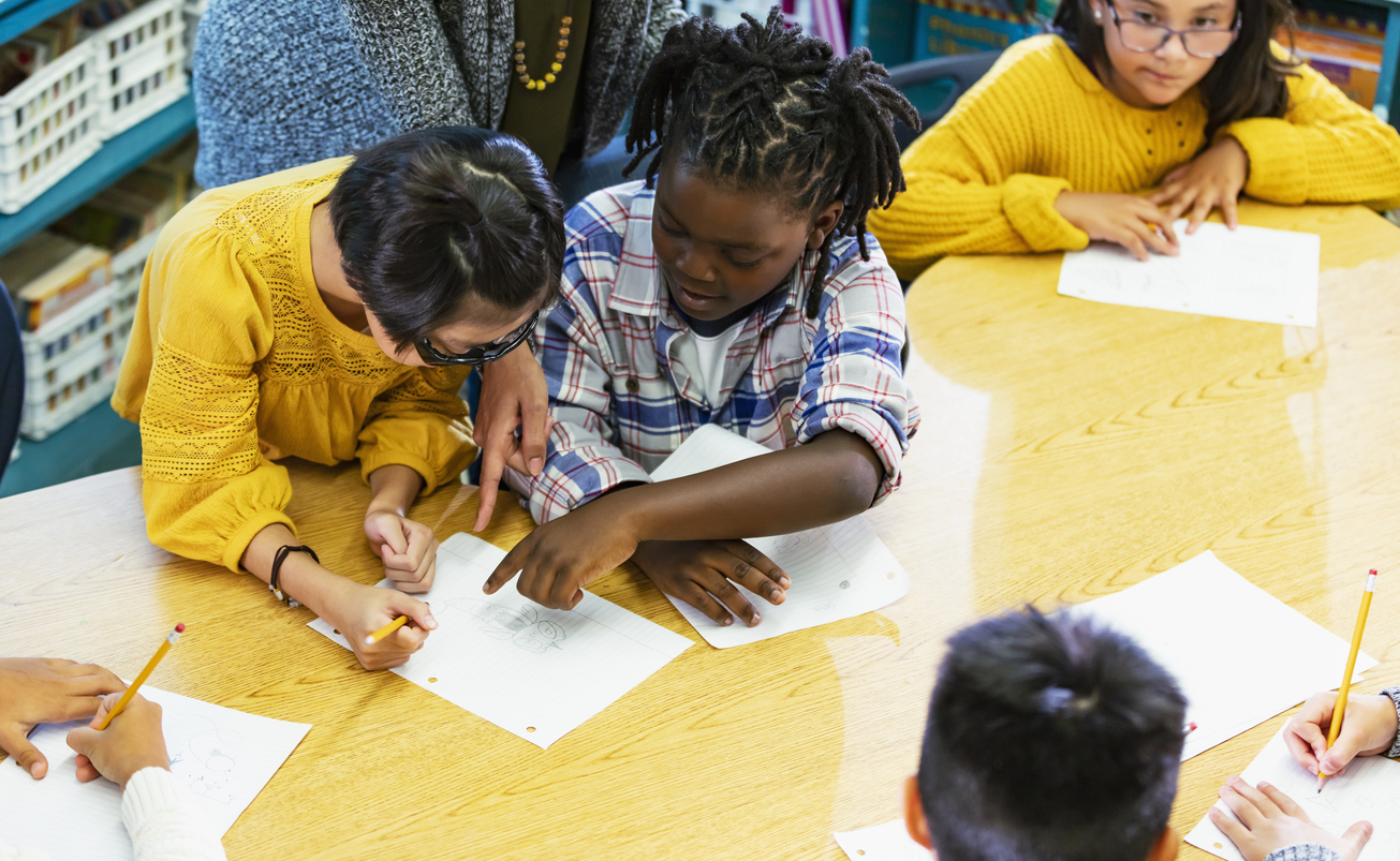  elementary students do schoolwork in class stock phot