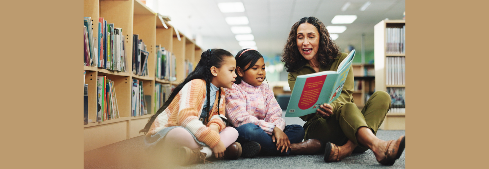 Girl, teacher and book with reading at library for development, learning or study with guide. School kids, storytelling and woman with help on floor, education and language for knowledge at academy