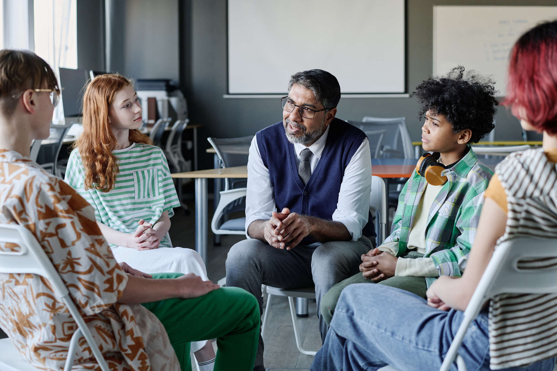 Psychologist Talking To Group Of Teenagers stock photo