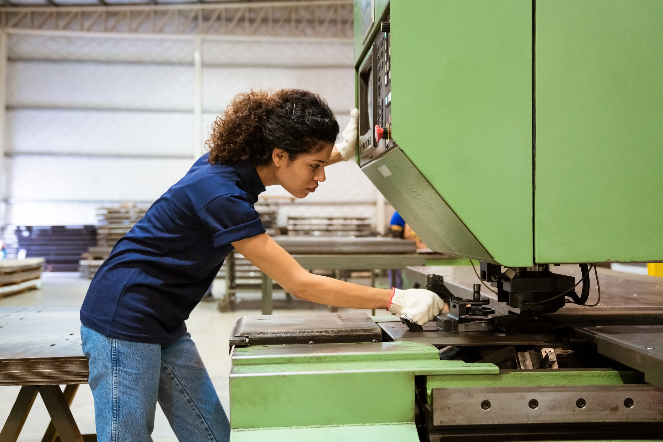 female engineer using machine at a factory