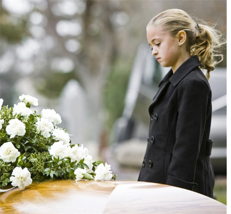 child viewing a casket